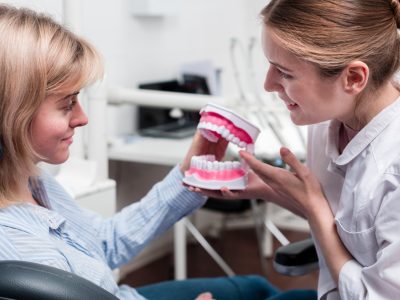 dentist with patient discussing on dental implant healing stages