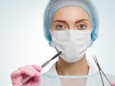 surgeon holding surgical instruments